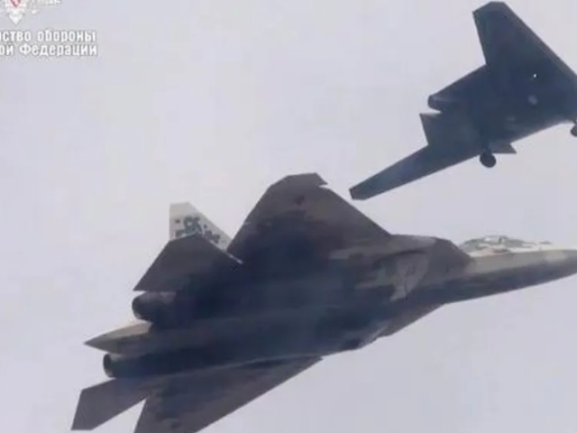 This old Russian defence ministry picture shows the Su-57 jet flying in tandem with an earlier version of the Okhotnik combat drone Photo: BBC